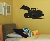 Black silhouette of a loader construction vehicle with large scoop and visible cabin, set against white background
