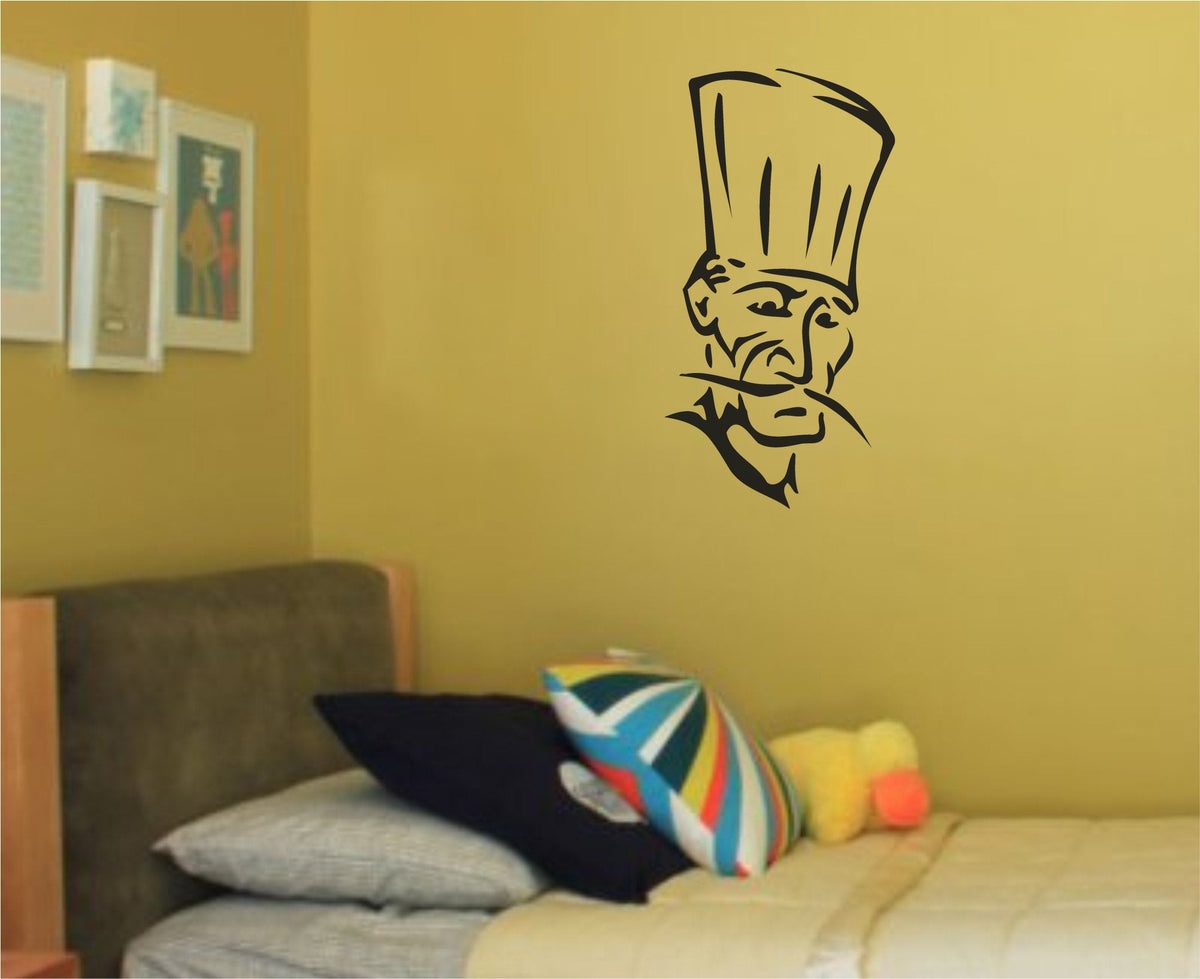 Black vinyl silhouette of a chef with a tall chef’s hat and mustache in a stylized line art illustration.