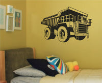 Black and white silhouette of a large mining dump truck with oversized wheels and detailed cab in a bold graphic style
