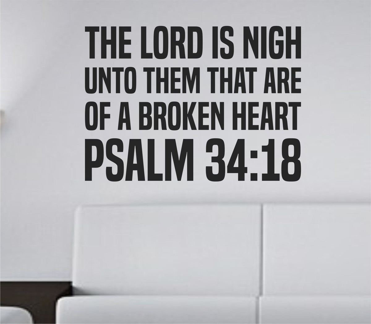 Bold black vinyl wall decal of Psalm 34:18 Bible verse in tall block letters on white background, Christian scripture quote