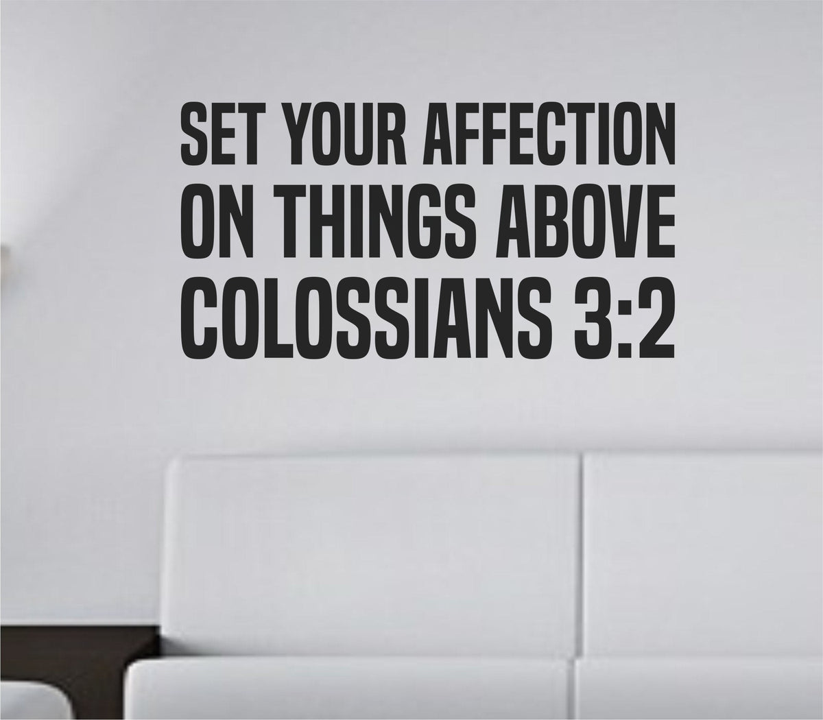 Black bold block lettering vinyl wall decal displaying Colossians 3:2 scripture on a white background