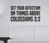Black bold block lettering vinyl wall decal displaying Colossians 3:2 scripture on a white background