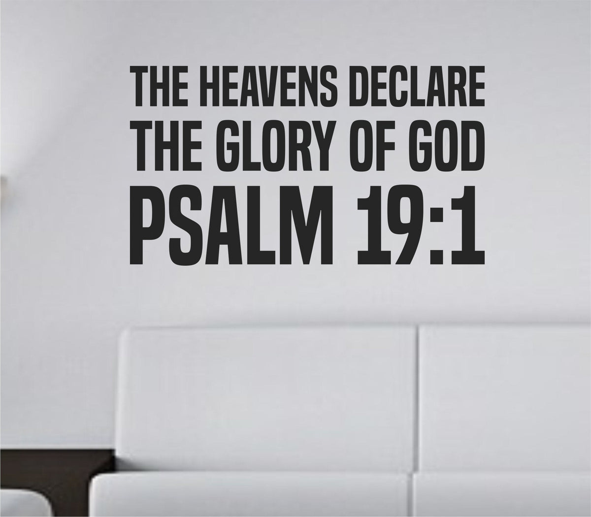 Bold tall block lettering vinyl wall decal with the scripture Psalm 19:1 The Heavens Declare The Glory Of God in black on white background.