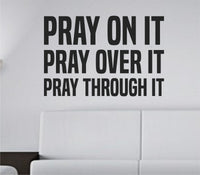 Black bold tall block lettering vinyl wall decal with the words Pray On It Pray Over It Pray Through It on white background