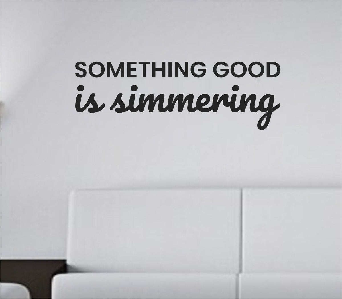 Black vinyl wall decal with the quote 'Something Good Is Simmering' in clean, modern script on a white background.