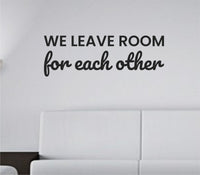 Black vinyl wall decal with the quote 'We Leave Room For Each Other' in simple, modern lettering on a white background