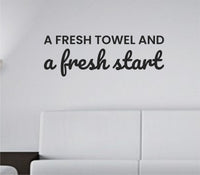 Black vinyl wall decal with the quote 'A fresh towel and a fresh start' in clean simple font on a white background