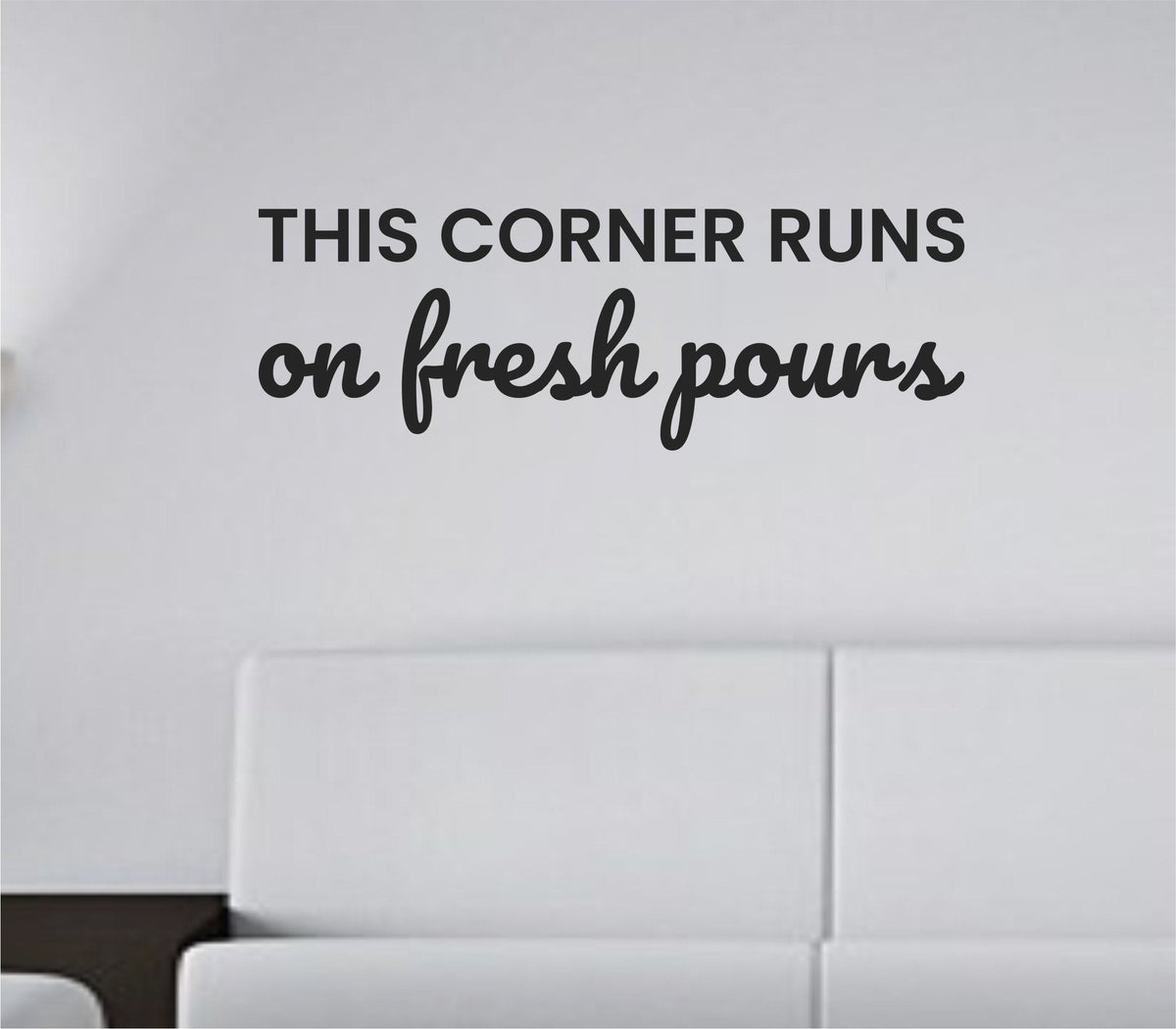 Black vinyl wall decal with the phrase This corner runs on fresh pours in clean, modern typography on a white background.
