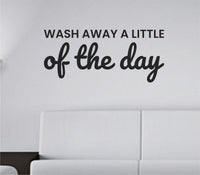 Black vinyl wall decal with the phrase 'Wash away a little of the day.' in a clean, modern font on a white background.