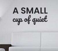Black vinyl wall decal with the phrase 'A small cup of quiet.' in simple, clean lettering on a white background.