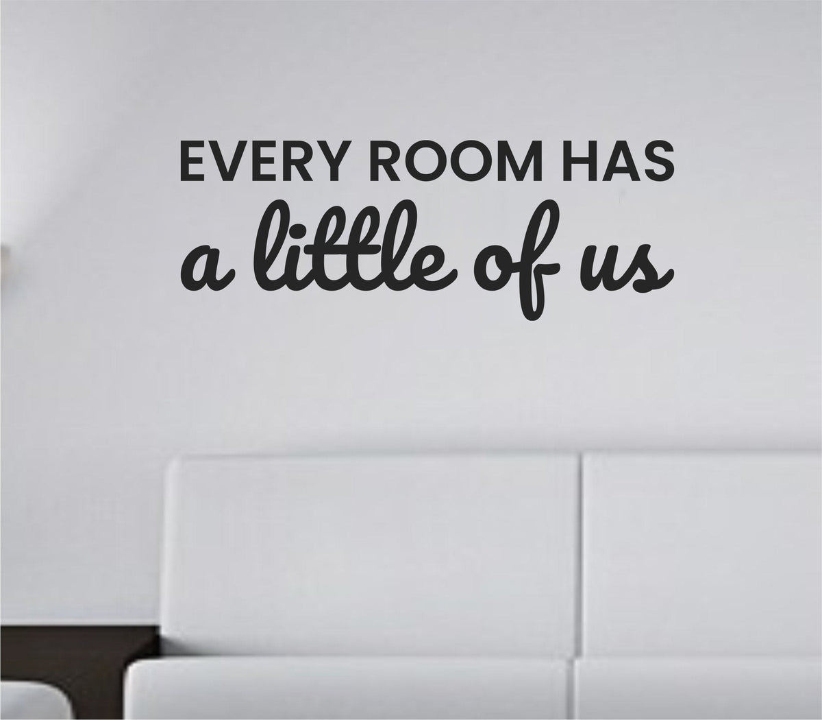 Black vinyl wall decal text reading 'Every room has a little of us' in simple, modern font on white background.