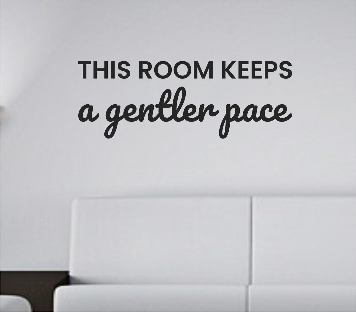 Black vinyl wall decal with the quote This room keeps a gentler pace in a simple, modern font on a white background.