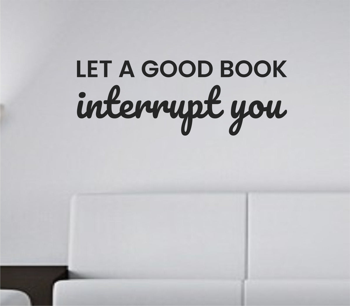Black vinyl wall decal with the quote Let a good book interrupt you in clean, modern lettering on a white background