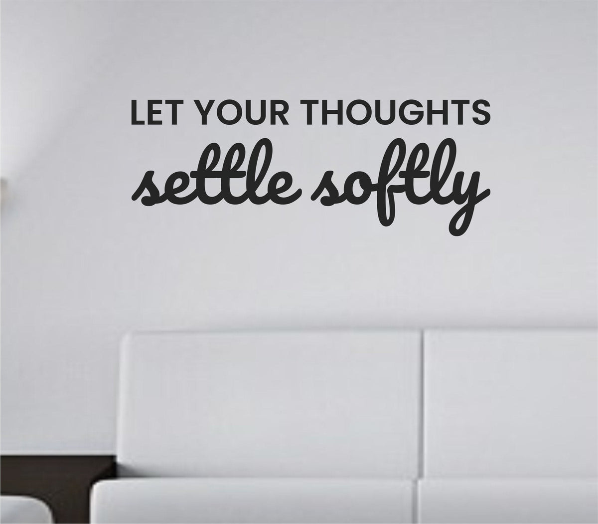 Black vinyl wall decal with the quote 'Let your thoughts settle softly' in simple, elegant script on a white background.