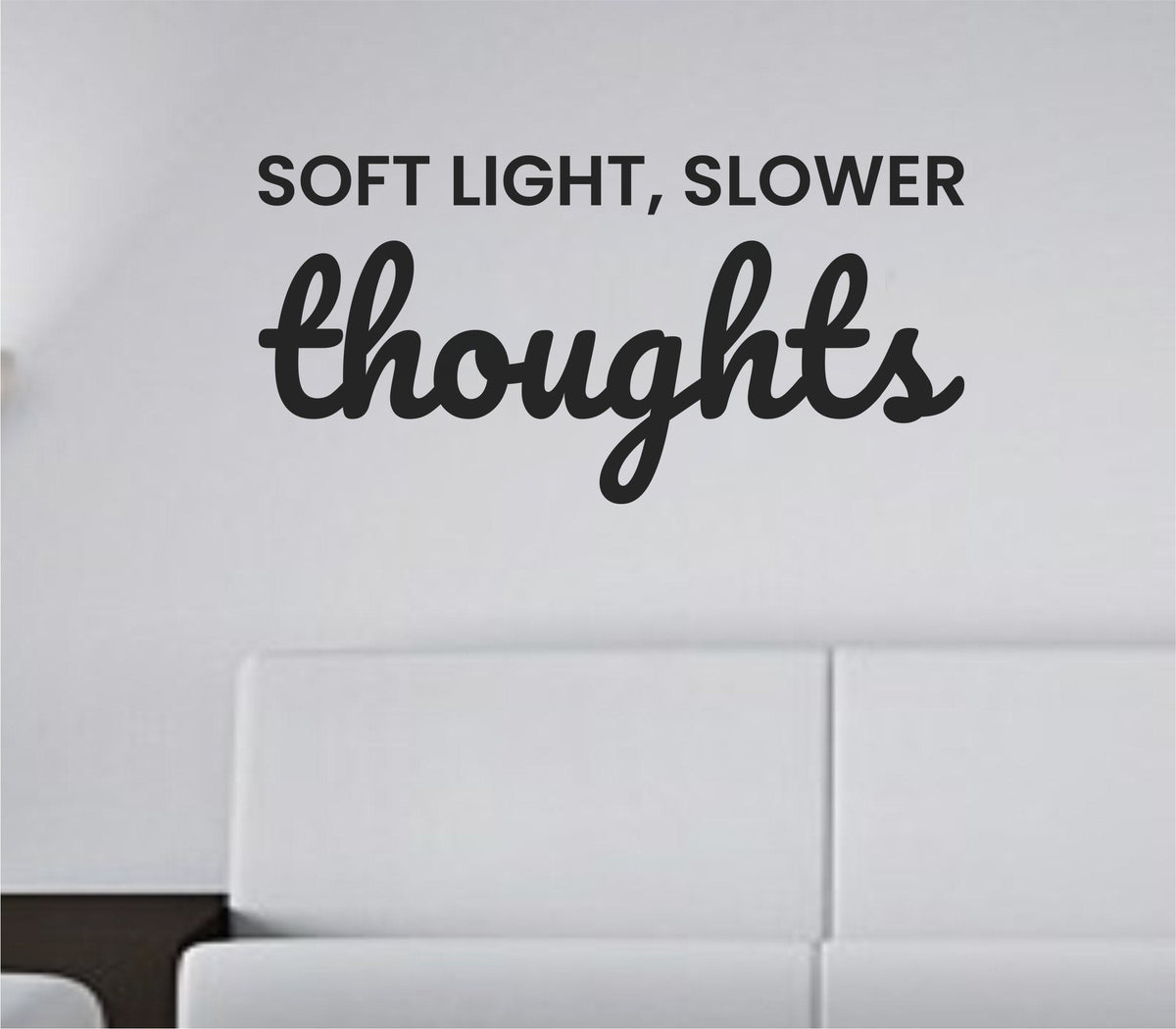 Simple black vinyl wall decal with the quote 'Soft light, slower thoughts.' in a smooth, modern font on a white background.