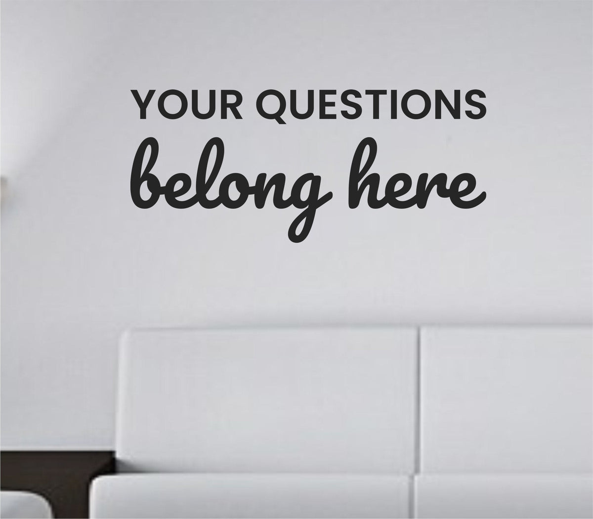 Black vinyl wall decal with the quote ‘Your questions belong here.’ in simple, bold lettering, on a white background.