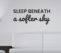 Black vinyl wall decal with the quote ‘Sleep beneath a softer sky’ in a simple, elegant script on a white background.