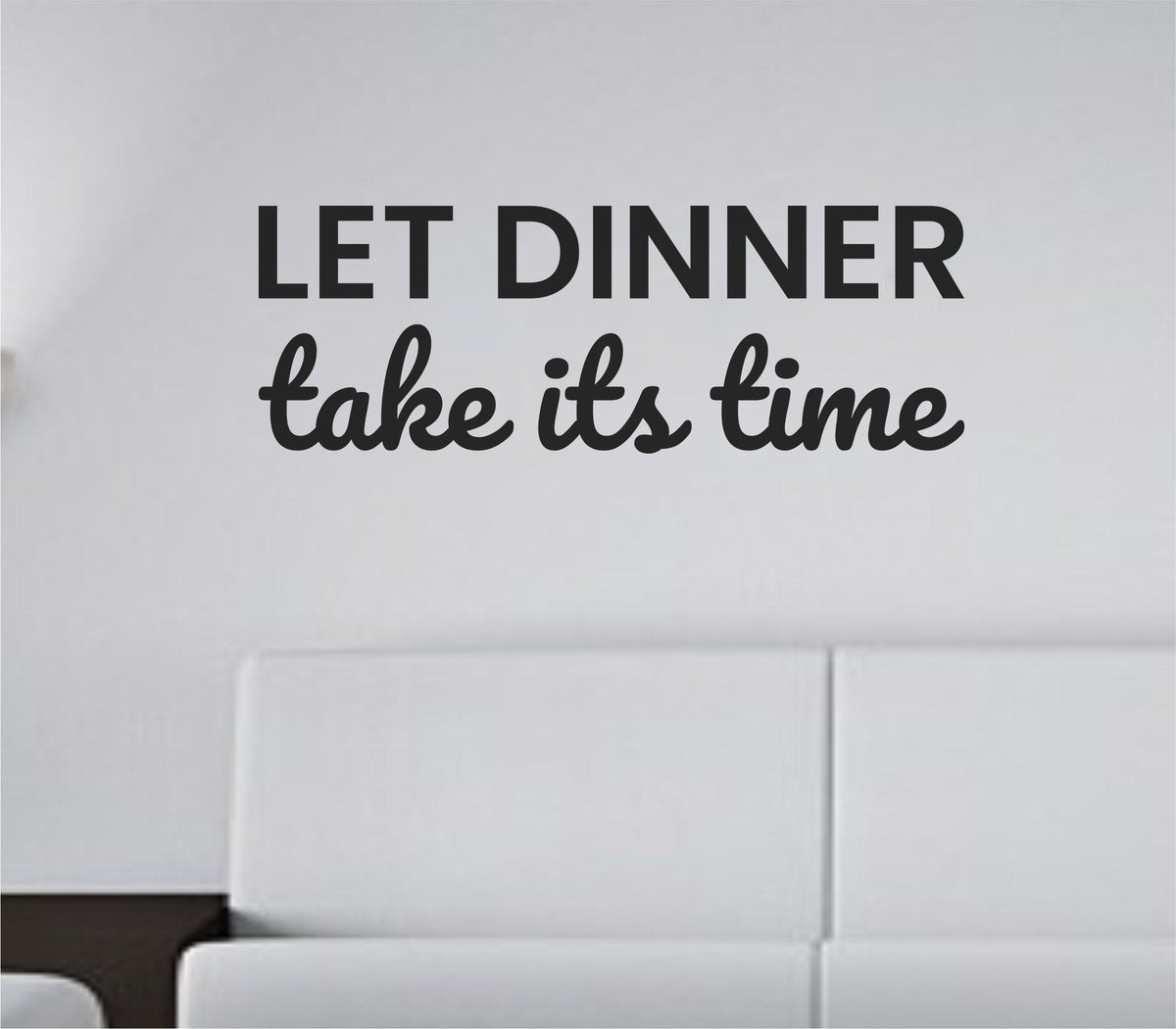 Black vinyl wall decal with the phrase Let dinner take its time in a casual script font on a white background.
