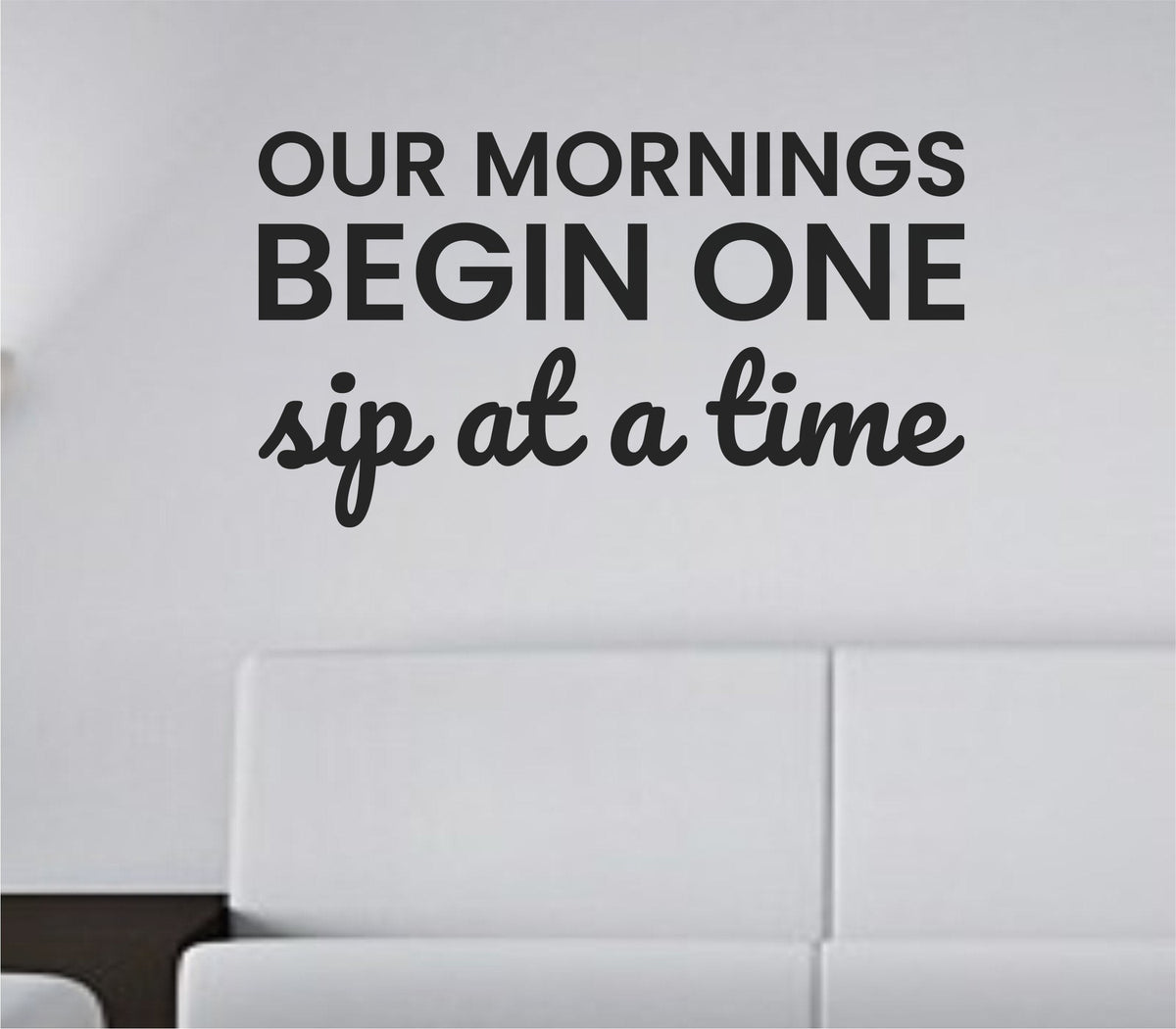 Black one-color vinyl wall decal with the quote Our mornings begin one sip at a time in a clean modern script style on a white background.