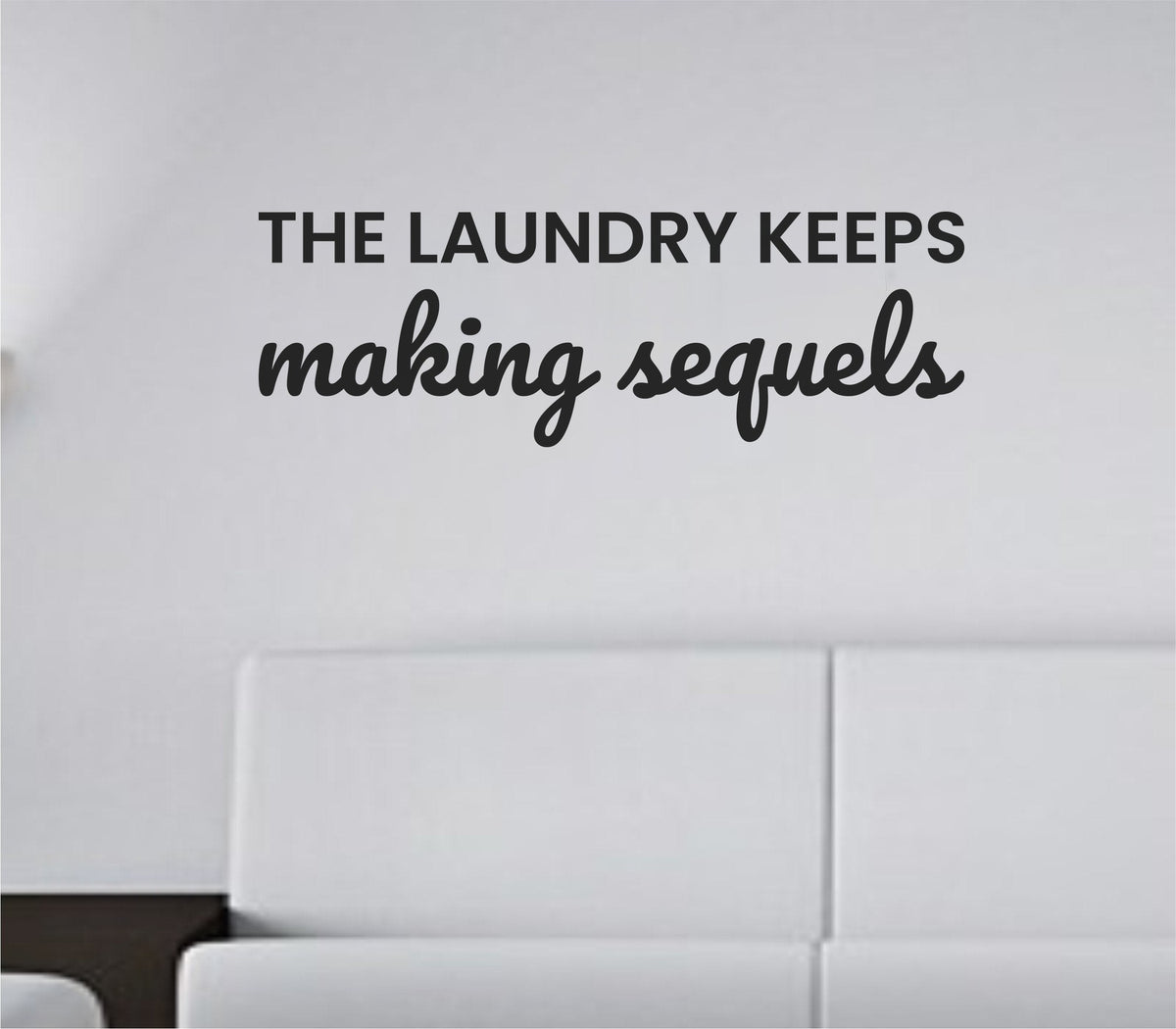 Black vinyl wall decal with the phrase 'The laundry keeps making sequels.' displayed on a plain white background in a clean modern font.