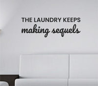 Black vinyl wall decal with the phrase 'The laundry keeps making sequels.' displayed on a plain white background in a clean modern font.