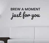 Black vinyl wall decal with the quote 'Brew a moment just for you.' in a simple, elegant script style on a white background.