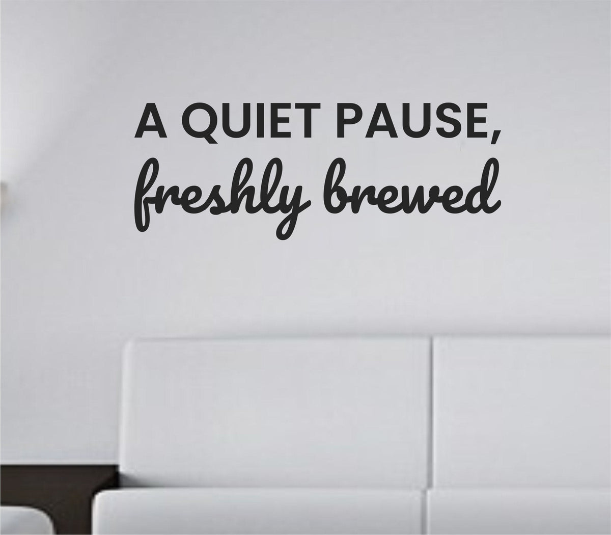 Black vinyl wall decal with the quote 'A quiet pause, freshly brewed.' in simple elegant script on a white background.
