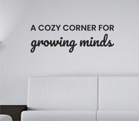 Black vinyl wall decal with the quote A Cozy Corner For Growing Minds in a simple, elegant font on a white background