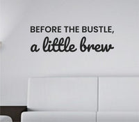 Black vinyl wall decal with the quote 'Before the bustle, a little brew.' in a simple script style on a white background.