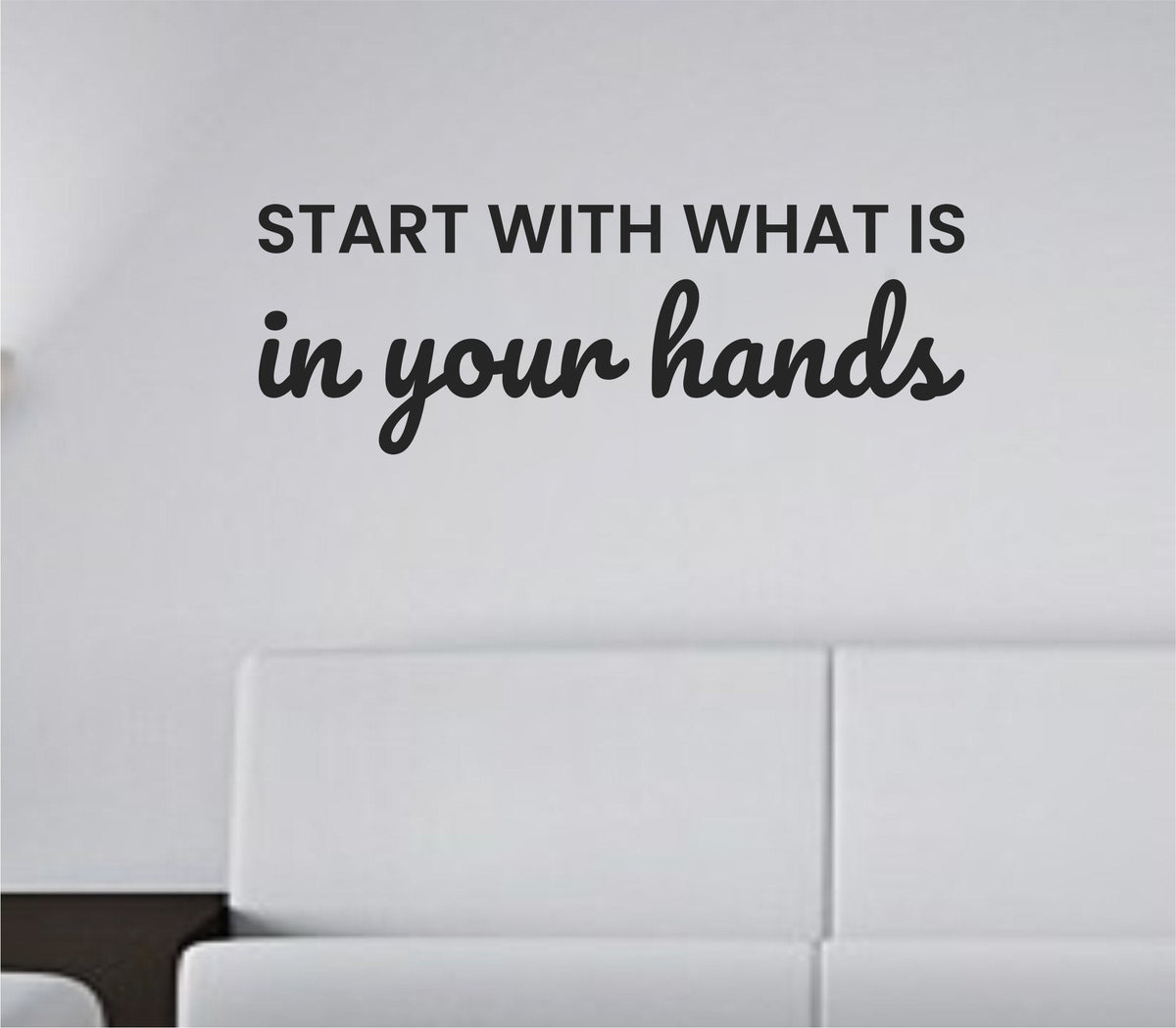 Black vinyl wall decal with the phrase Start with what is in your hands in a modern script and block lettering on a white background