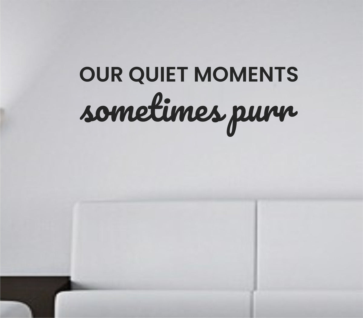 Black vinyl wall decal with the quote Our quiet moments sometimes purr in playful script on a white background