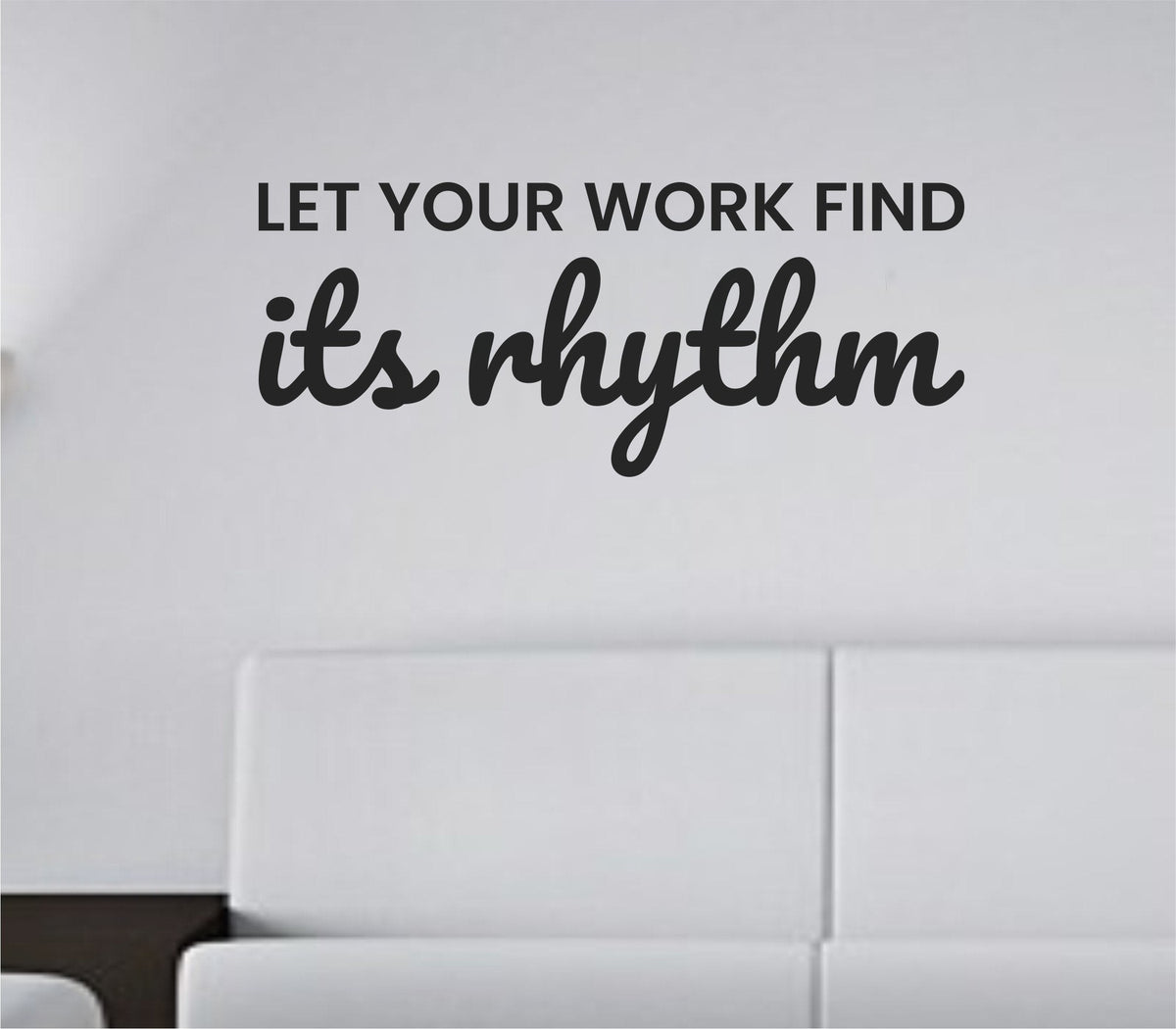 Black vinyl wall decal with the phrase 'Let your work find its rhythm' in simple, modern typography on a white background.