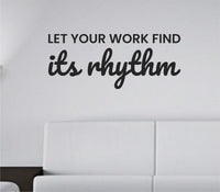 Black vinyl wall decal with the phrase 'Let your work find its rhythm' in simple, modern typography on a white background.