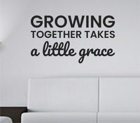 Black vinyl wall decal with the quote "Growing together takes a little grace" in a simple, elegant font on a white background.