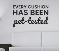 Black vinyl wall decal with the phrase Every cushion has been pet-tested in playful font on white background