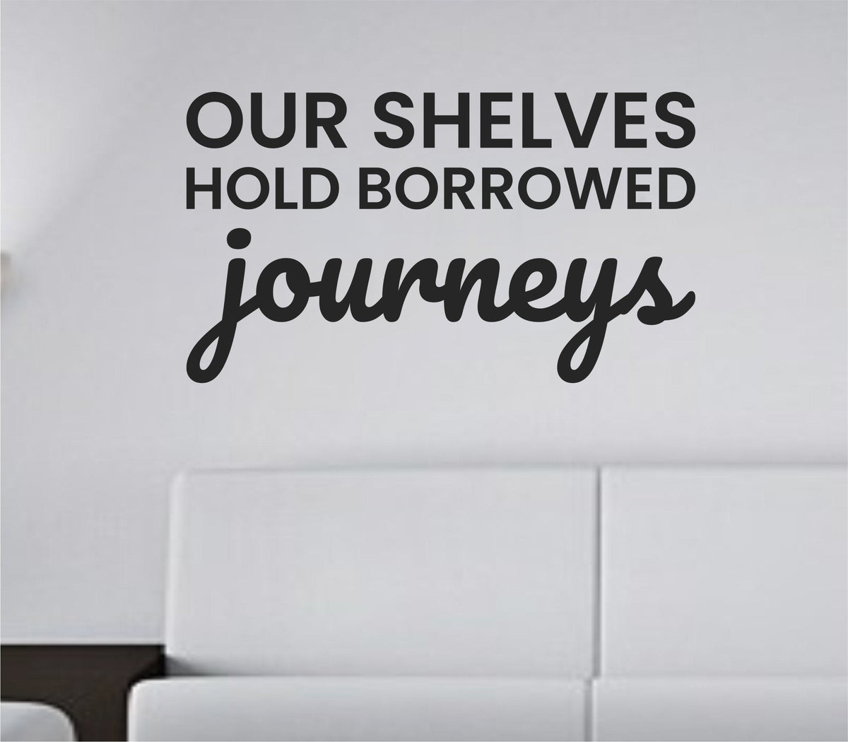 Black vinyl wall decal with the quote 'Our shelves hold borrowed journeys.' in a clean, modern script on a white background.