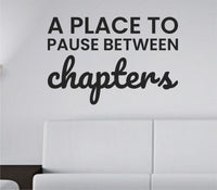 Black one-color vinyl wall decal with the quote 'A place to pause between chapters' in simple, elegant lettering on a white background.