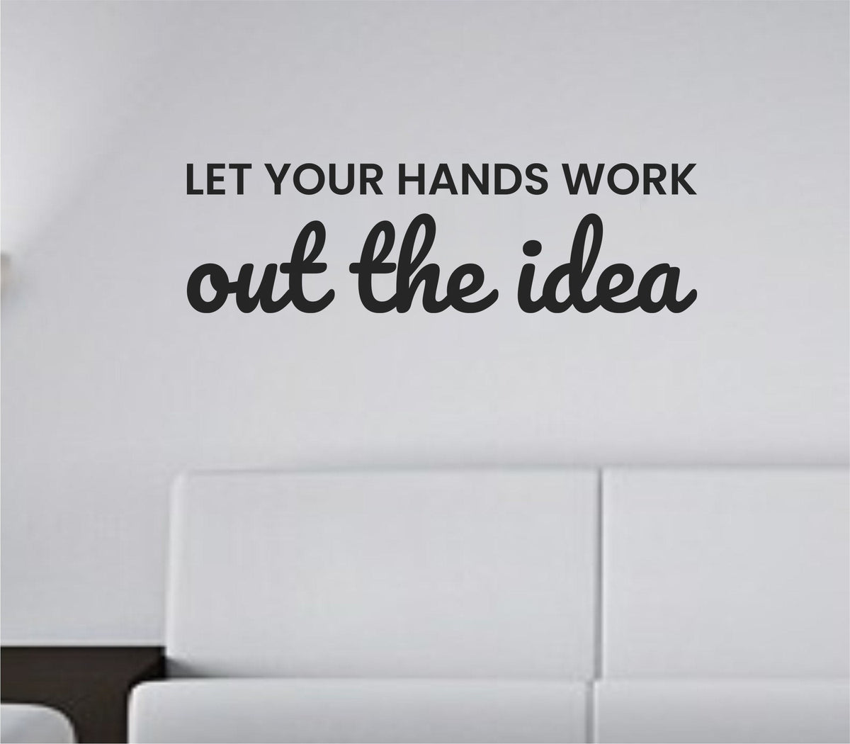 Black vinyl wall decal with the quote Let your hands work out the idea in a flowing script font on a white background