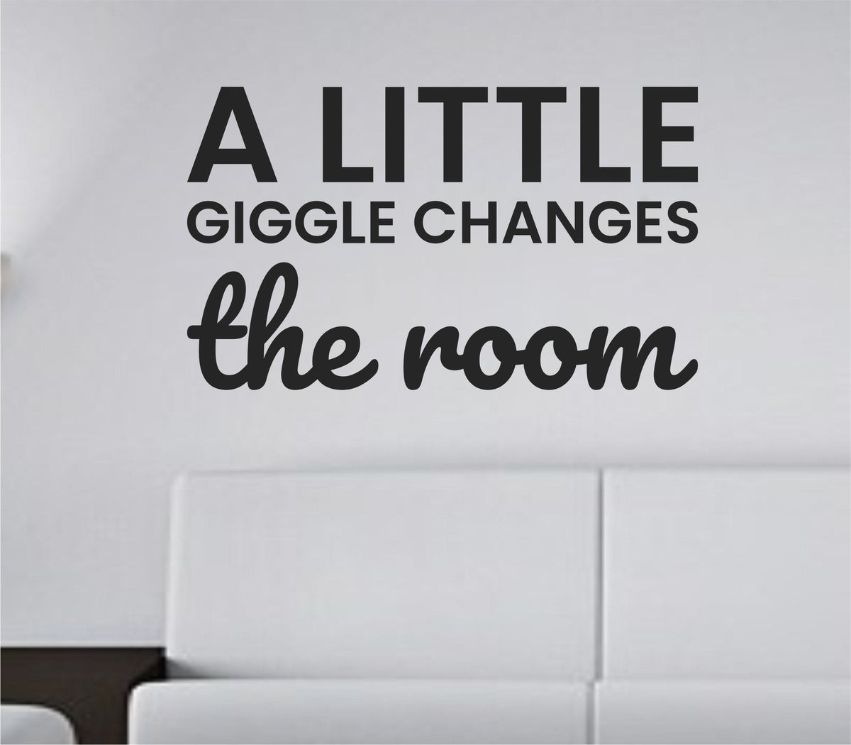 Black vinyl wall decal with the phrase A little giggle changes the room in playful handwritten script on a white background.