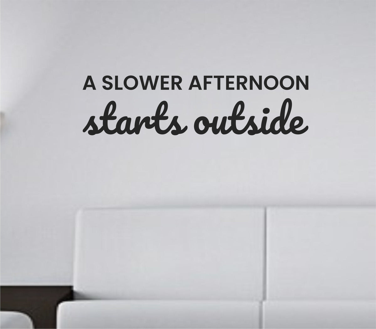 Black vinyl wall decal with the phrase A slower afternoon starts outside in a simple, elegant font on a white background