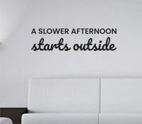 Black vinyl wall decal with the phrase A slower afternoon starts outside in a simple, elegant font on a white background