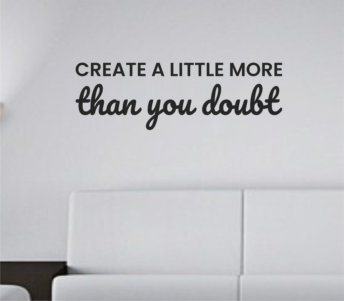 Black vinyl wall decal with the motivational quote 'Create a little more than you doubt' in a clean, modern font on a white background