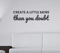 Black vinyl wall decal with the motivational quote 'Create a little more than you doubt' in a clean, modern font on a white background