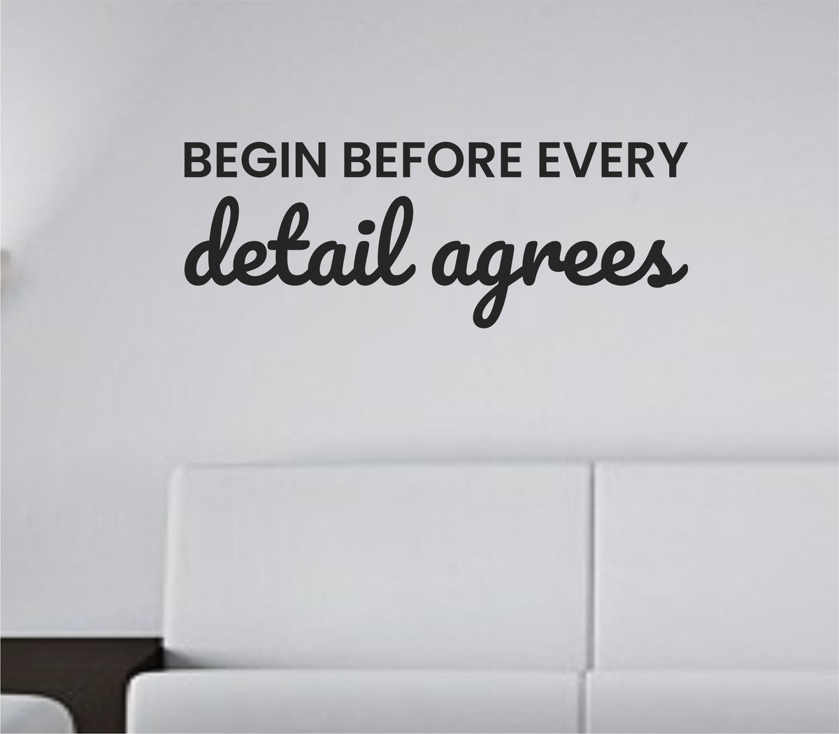 Black vinyl wall decal with the phrase Begin before every detail agrees in simple modern font on white background