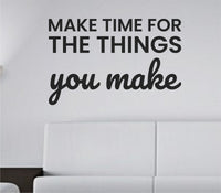 Black vinyl wall decal with the motivational quote 'Make time for the things you make' in a clean modern font on a white background.