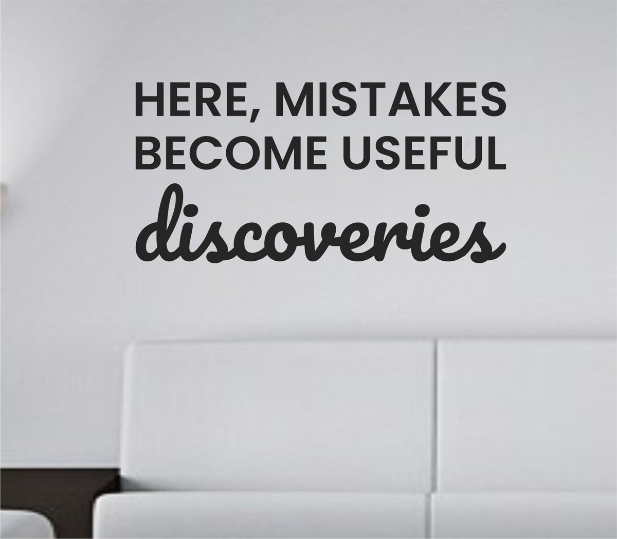Black vinyl wall decal with the quote 'Here, mistakes become useful discoveries' in a clean modern font on a white background
