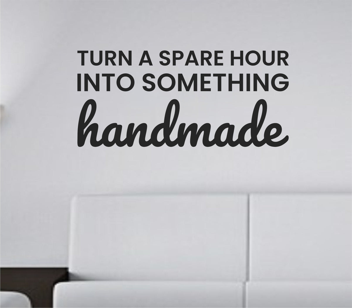 Black vinyl wall decal with the quote 'Turn a spare hour into something handmade' in a simple, elegant font on a white background.