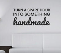 Black vinyl wall decal with the quote 'Turn a spare hour into something handmade' in a simple, elegant font on a white background.