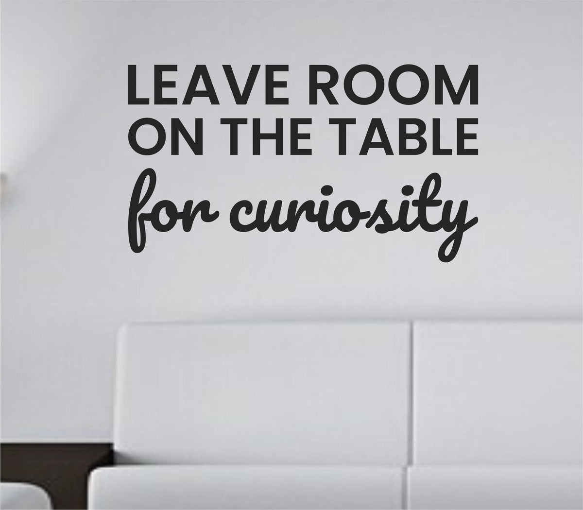 Black vinyl wall decal with the quote 'Leave room on the table for curiosity' in a simple, clean font on a white background.