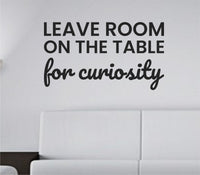 Black vinyl wall decal with the quote 'Leave room on the table for curiosity' in a simple, clean font on a white background.